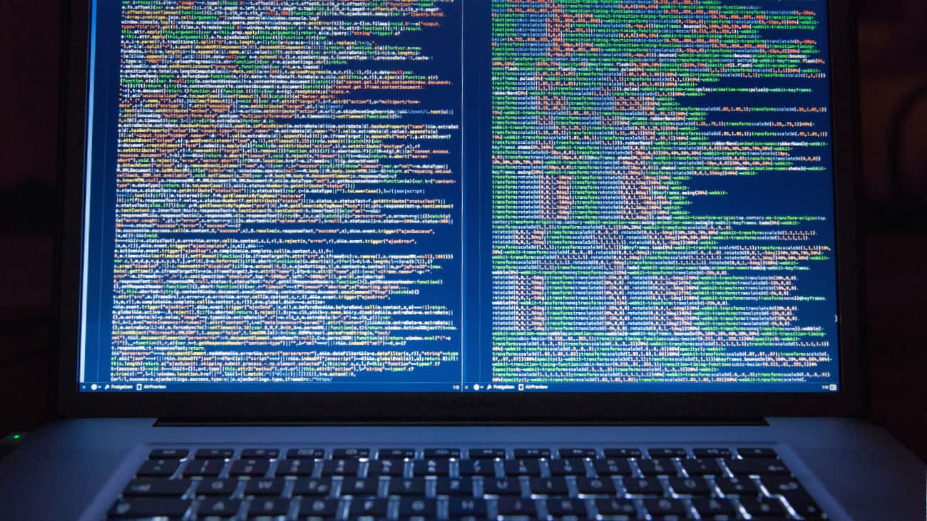 Laptop with blue screen showing colourful code