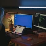 Person sitting at computer messaging ISO 27001 consultant