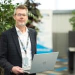 Senior Security Consultant holding laptop