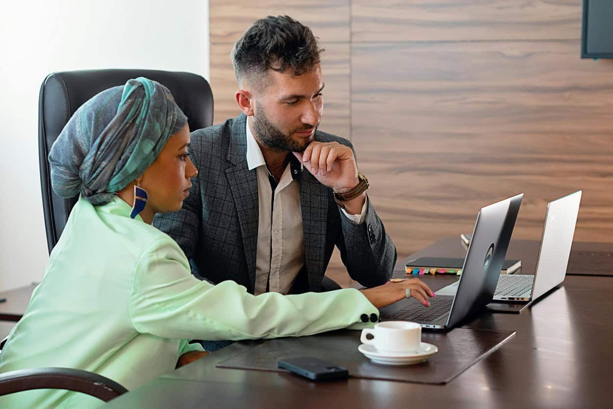 Co-workers comparing the benefits of penetration testing vs vulnerability scanning